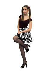 Naklejka premium Young pin up girl in polka-dot dress, black stockings and in high heels shoes isolated on the white background.