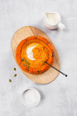 Traditional pumpkin soup in the plate of whole small pumpkin