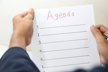 hand holding business agenda list