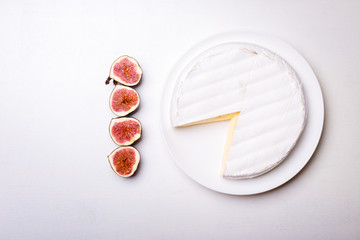 Soft creamy brie cheese with cut in half figs