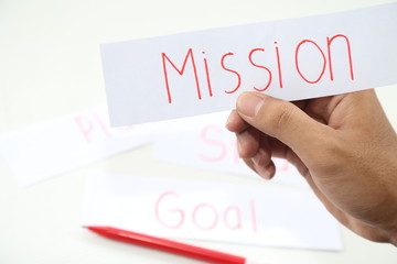 Fototapeta premium business hand writing a piece of mission paper