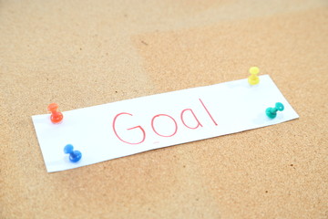 a piece of business goal paper with paper pin