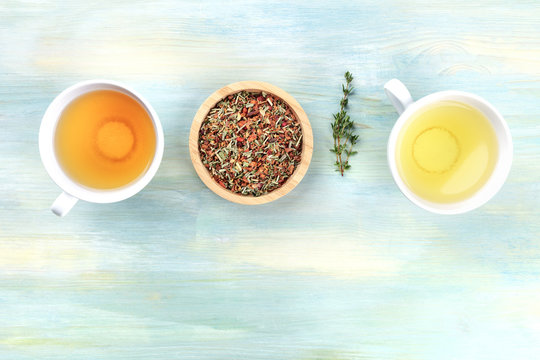 An overhead photo of tea on a teal background with copyspace