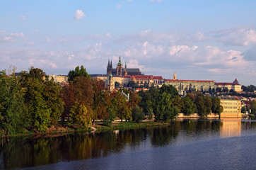Fototapeta na wymiar Picturesque view of the historical part of the city Prague in morning. Medieval Charles Bridge over Vltava River and Strelecky Island. Prague Castle with Saint Vitus Cathedral at the background