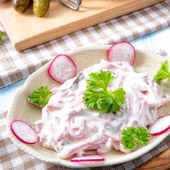 delicious homemade meat salad with mayonnaise and cucumber