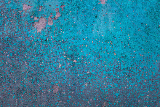 bright blue texture of cracked paint covering a metal surface close-up
