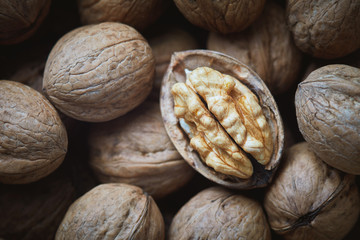 Closeup of whole and kernel walnuts. Top view