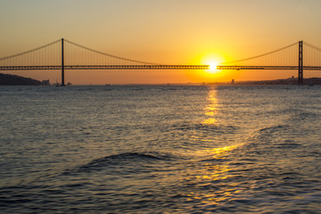 Naklejka na ściany i meble Bridge over water at sunset