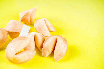 Fototapeta na wymiar Chinese fortune cookie with prediction on bright yellow background top view copy space