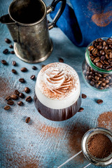 Autumn espresso drink ideas, Irish coffee cocktail with whipped cream and cocoa, blue concrete background copy space