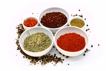 different spices in a white ceramic cup, isolated