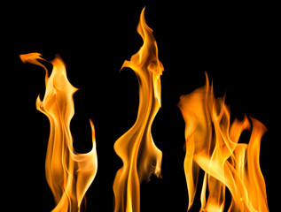 orange sparks of three bright flames on black