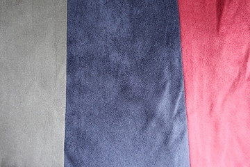 Grey, blue and red vertical strips of artificial suede sewn together