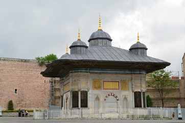 Fototapeta na wymiar Sultan Ahmet III fountain near Topkapi museum in Istanbul, Turkey