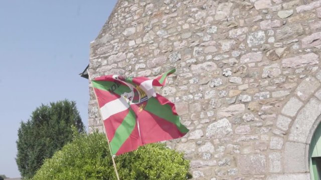 The basque flag in slow motion in front of a church