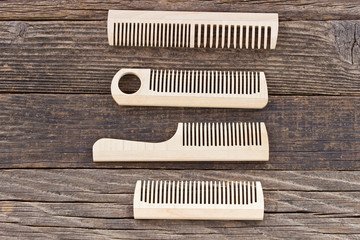 Combs on wooden background