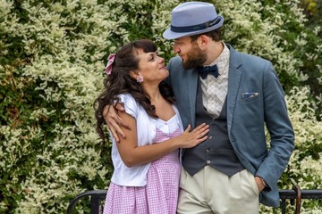 A couple of lovers dressed retro style in garden of  Montmartre, Paris, France