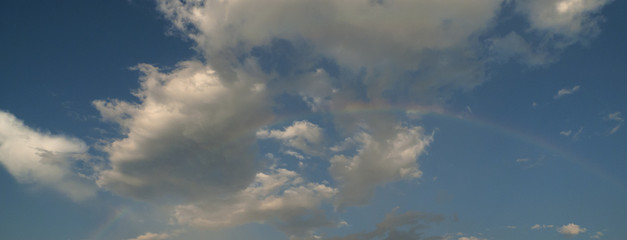 Rainbow and fair weather clouds