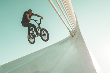 Young man doing street tricks with a bmx