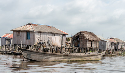 Fisherman fishing in Ganvié in Benin lake Nokoué lifestyle African villager living on house in...