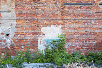 Abandoned grunge cracked red brick stucco wall