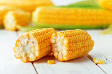 Raw corn on a wooden table