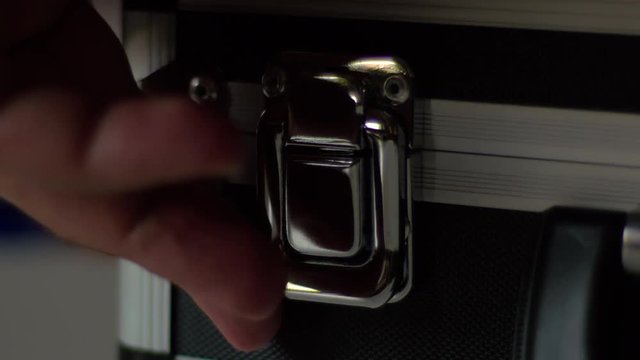 Man Open A Metal Suitcase