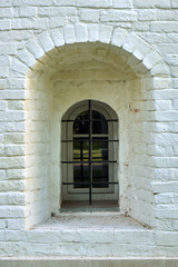 Narrow window in the wall of an ancient building in the Joseph-Volotsky russian monastery