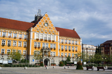 Naklejka premium Mestsky urad / Urzad miejski ( Town hall ), Cesky Tesin / Czeski Cieszyn, Silesia, Czech Republic, Central Europe - square and orange building of municipality made in neo-renaissance style