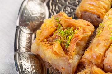 Turkish sweets baklava and metal oriental tray on wooden background