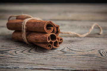 Cinnamon sticks on wooden background.