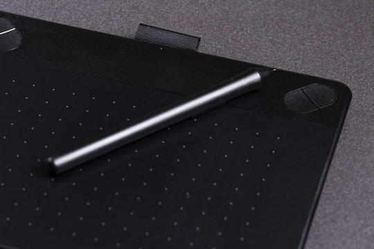Black Graphic tablet with pen closeup.