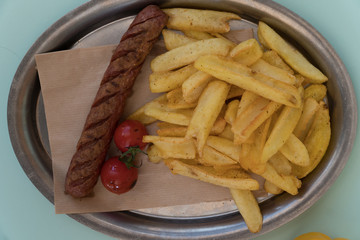 Grilled sausage with sauce and french fries