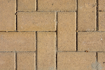 Sand Colored Brick Stone Pavement on The Ground for Street Road. Sidewalk, Driveway, Pavers, Pavement in Square Pattern Texture Background.