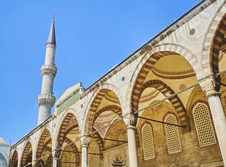Arcaded courtyard of The Sultan Ahmet Camii Mosque, also known as The Blue Mosque, with a minaret...