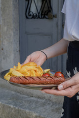 Grilled sausage with sauce and french fries