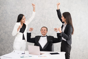 Celebrating success Cheerful young people looking excited. Successful entrepreneurs and business people achieving goals