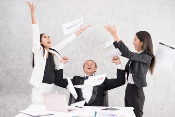 Celebrating success Cheerful young people looking excited. Successful entrepreneurs and business people achieving goals