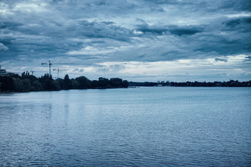 Alster skyline Hamburg, Germany under a dramatic sky blue crane