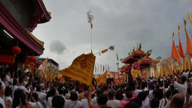 Phuket,Thailand- 8 October 2018- At Juitui Shrine, raise up sacred bamboo pole with 9 lamps, symbol of beginning vegetarian festival. Chinese god spiritual medium pray for god and moving holy flag.