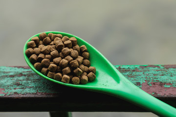 Animal feeds ladle on steel fence