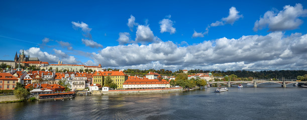 Fototapeta premium Bright and beautiful autumn view on Vltava river, Saint Vitus Cathedral and Prague Castle, Prague, Czech Republic