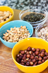 Assortment of mixed nuts on wood table background 