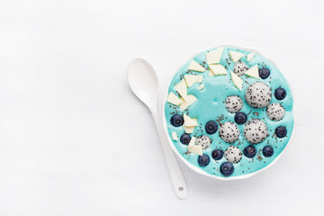 healthy blue spirulina smoothie bowl with blueberry, white chocolate, dragon fruit, chia seed