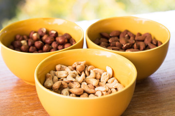 Assortment of mixed nuts on wood table background 