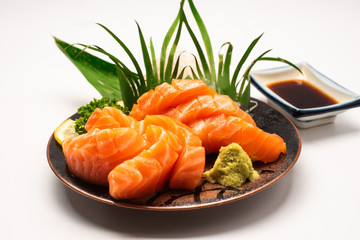 Sashimi, Salmon, Japanese food chopsticks and wasabi with withe plate isolated