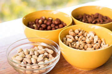 Assortment of mixed nuts on wood table background 