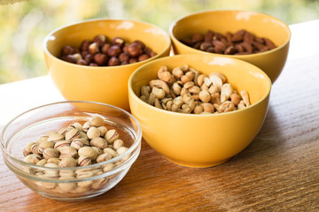 Assortment of mixed nuts on wood table background 