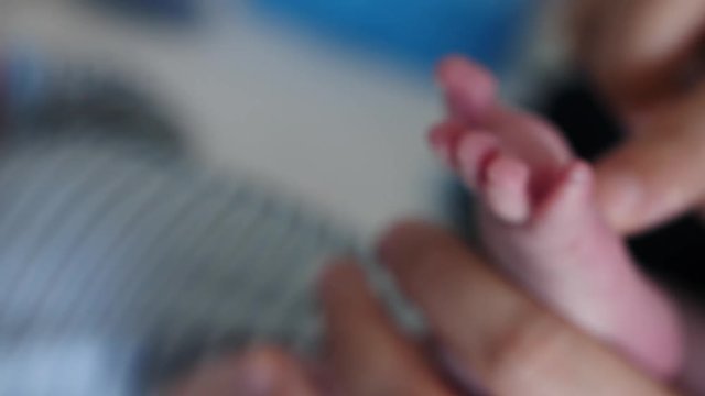 caress new born Baby feet