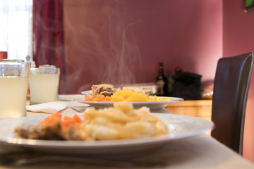 table with steaming plate of food 